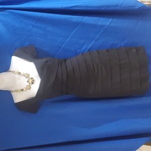 White House Black Market black cocktail dress with necklace and earrings.